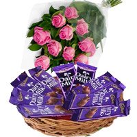 Send Diwali Gifts to Bangalore Online that includes Dairy Milk Basket 12 Chocolates With 12 Pink Roses