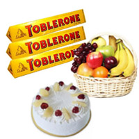 Online 500gm Pineapple Cake with 1 Kg Fresh Fruits Basket and Toblerone Chocolates as gifts in Bangalore